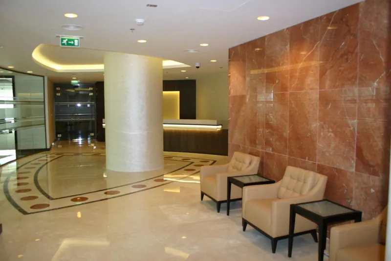 Marble lobby with onyx feature wall and lounge seating, Qatar Railways, Doha — DIM Mobilya
